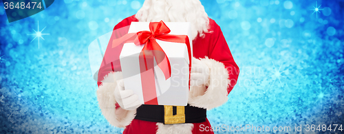 Image of man in costume of santa claus with gift box