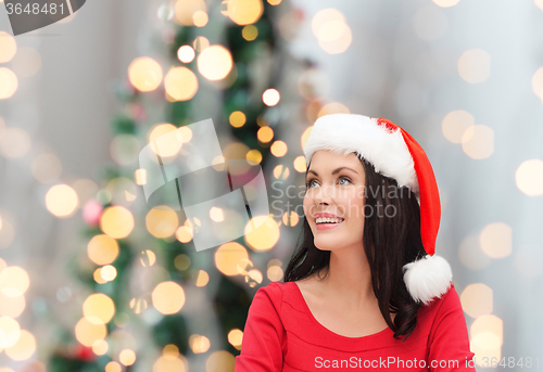 Image of smiling woman in santa helper hat