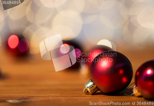 Image of close up of red christmas balls on wood