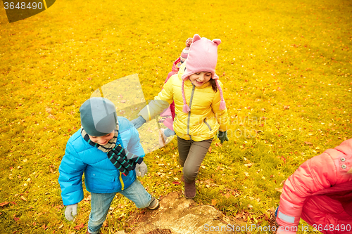 Image of group of happy children having fun in autumn park