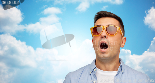 Image of face of scared man in shirt and sunglasses