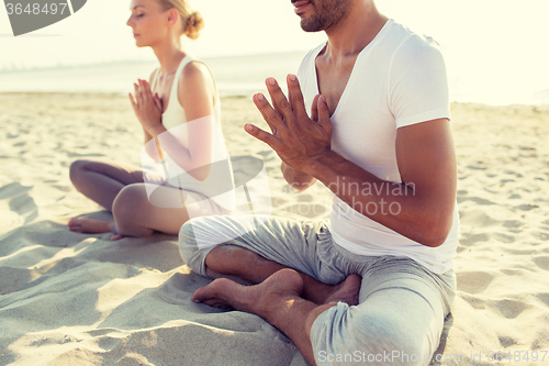 Image of close up of couple making yoga exercises outdoors