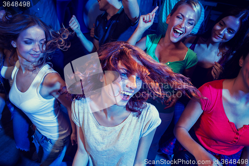 Image of smiling friends dancing in club