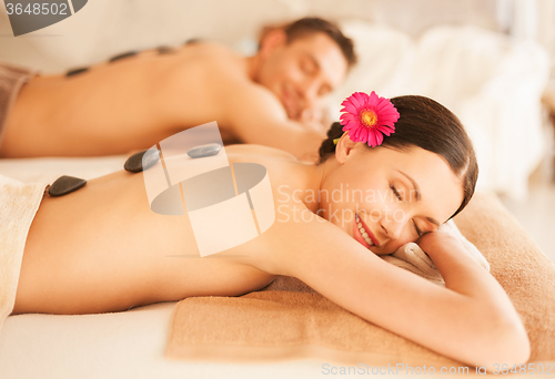 Image of couple in spa with hot stones