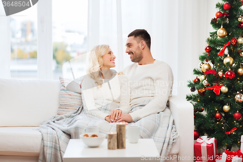 Image of happy couple at home with christmas tree