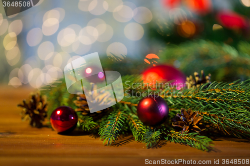 Image of fir branch with christmas ball and pinecones