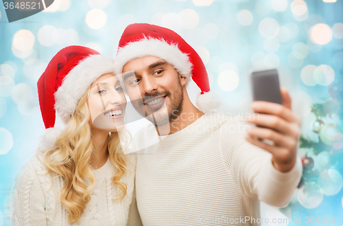 Image of couple taking selfie with smartphone at christmas