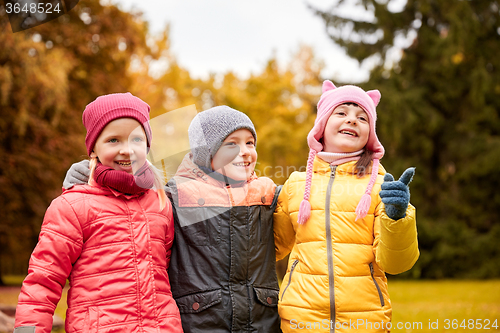 Image of group of happy children hugging in autumn park