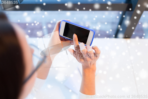 Image of close up of woman with smartphone at office