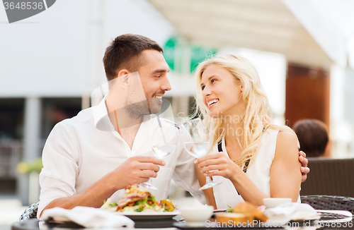 Image of happy couple clinking glasses at restaurant lounge