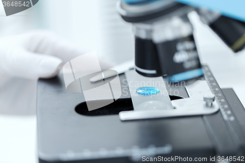 Image of close up of scientist hand with test sample in lab