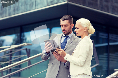 Image of businesspeople with tablet pc outdoors