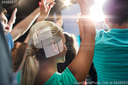 Image of close up of happy people at concert in night club