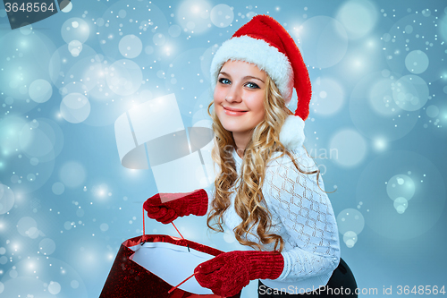 Image of Beautiful young woman in Santa Claus clothes