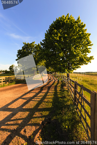 Image of rural road . wooden fence