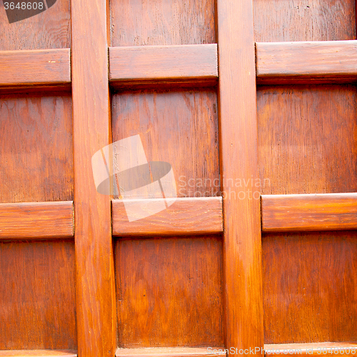Image of home texture of a brown antique wooden old door in italy   europ