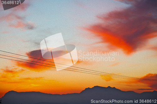 Image of mountain in morocco africa   current cables     and red sunrise