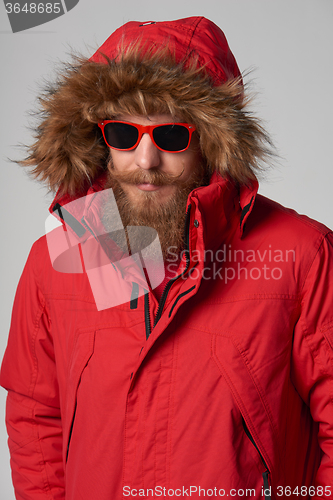 Image of Man wearing red winter Alaska jacket  with fur hood on