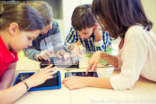 Image of group of school kids with tablet pc in classroom