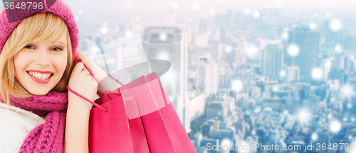 Image of smiling young woman with shopping bags