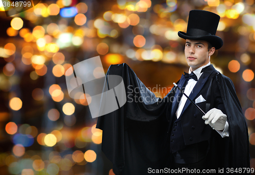 Image of magician in top hat showing trick with magic wand