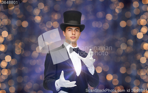 Image of magician in top hat showing trick