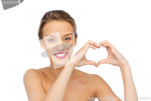 Image of smiling young woman showing heart shape hand sign