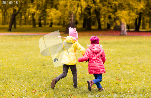 Image of happy little girls running outdoors