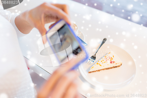 Image of woman hands with smartphone taking food picture