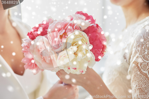 Image of close up of happy lesbian couple with flowers