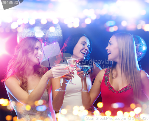 Image of smiling women with cocktails at night club