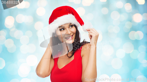 Image of beautiful sexy woman in santa hat and red dress