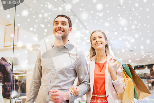 Image of happy young couple with shopping bags in mall