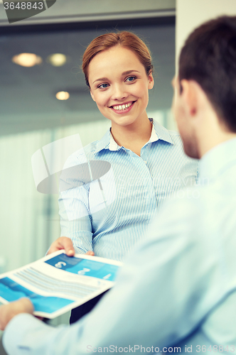 Image of group of smiling businesspeople meeting in office