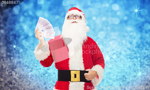 Image of man in costume of santa claus with euro money