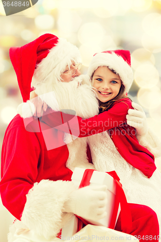 Image of smiling little girl with santa claus