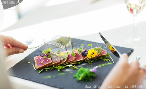 Image of close up of woman eating salad at restaurant