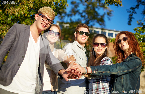 Image of group of students or teenagers with hands on top