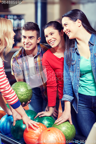 Image of happy friends in bowling club