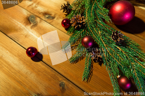 Image of fir branch with christmas ball and pinecones