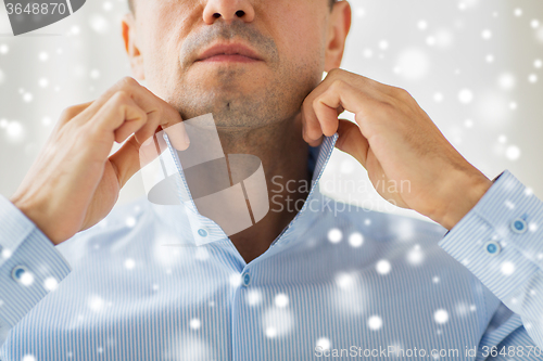 Image of close up of man in shirt dressing