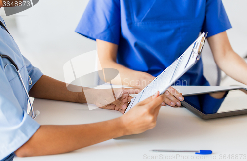 Image of close up of doctor with medical report at hospital