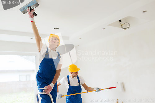 Image of group of builders with tools indoors