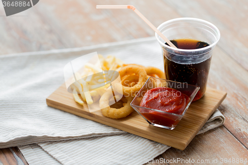 Image of close up of fast food snacks and drink on table