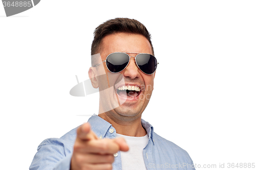 Image of laughing man in sunglasses pointing finger on you