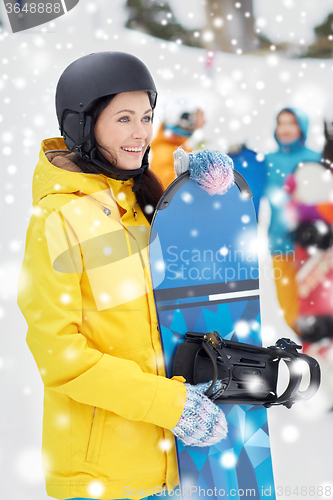 Image of happy friends in helmets with snowboards