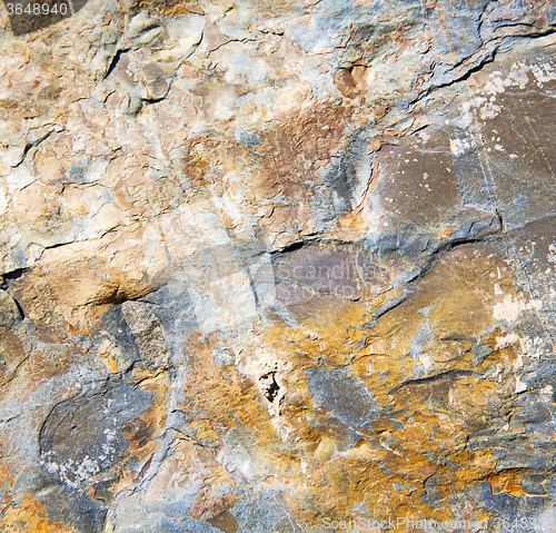 Image of rocks stone and red orange gneiss in the wall of morocco