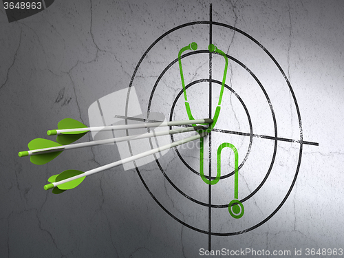 Image of Medicine concept: arrows in Stethoscope target on wall background