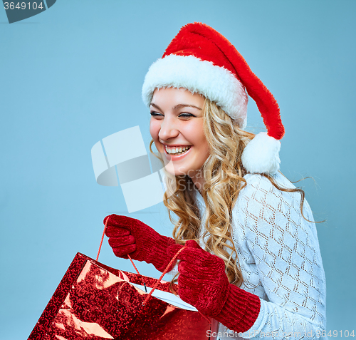 Image of Beautiful young woman in Santa Claus clothes