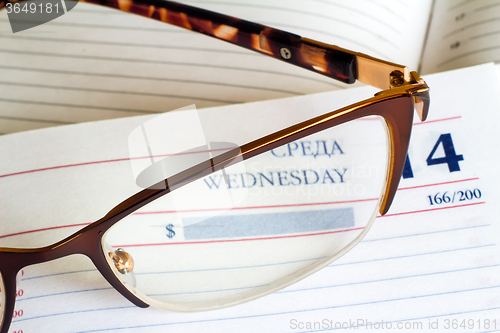 Image of Glasses and notebook .